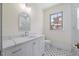 Elegant bathroom featuring quartz counters, patterned floor tiles, and a shower/tub combo at 512 S 4Th St, Smithfield, NC 27577