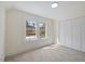 Sunny bedroom with a large window, neutral carpet and paint, and large closet at 512 S 4Th St, Smithfield, NC 27577