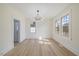 Bright dining room with hardwood floors, modern chandelier, and natural light from three large windows at 512 S 4Th St, Smithfield, NC 27577