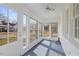 Bright sunroom enclosed with lots of windows, ceiling fan and access to the exterior at 512 S 4Th St, Smithfield, NC 27577