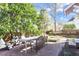 Inviting backyard with brick patio, mature trees, and a cozy outdoor dining setup at 516 N Bloodworth St, Raleigh, NC 27604