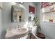 Charming bathroom featuring a vintage sink and toilet with natural light from the window at 516 N Bloodworth St, Raleigh, NC 27604