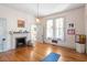 Bright, airy bedroom with hardwood floors, vintage fireplace, and natural light from large windows at 516 N Bloodworth St, Raleigh, NC 27604