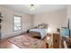 Bright bedroom with hardwood floors, decorative rug, and a large window with natural light at 516 N Bloodworth St, Raleigh, NC 27604