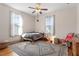 Cozy bedroom with natural light from the large windows, hardwood floors and a decorative rug at 516 N Bloodworth St, Raleigh, NC 27604
