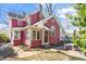 Charming red home with a brick walkway and inviting outdoor seating area at 516 N Bloodworth St, Raleigh, NC 27604
