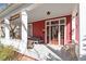 Inviting front porch with seating area, featuring a swing, rocking chairs, and vintage decor at 516 N Bloodworth St, Raleigh, NC 27604