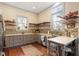 Well-lit kitchen with grey cabinetry, floating shelves, mosaic backsplash, and island with seating at 516 N Bloodworth St, Raleigh, NC 27604