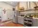 Updated kitchen with stainless steel appliances, grey cabinetry, and open shelving at 516 N Bloodworth St, Raleigh, NC 27604