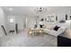 Inviting bonus room with a plush white sofa, round table, and stylish black chandelier at 517 Providence Springs Ln, Fuquay Varina, NC 27526