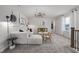 Comfortable bonus room featuring a white sofa, accent furniture, and modern decor at 517 Providence Springs Ln, Fuquay Varina, NC 27526