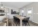 Inviting dining space with natural light, neutral tones, and wood-look flooring, adjacent to the kitchen at 517 Providence Springs Ln, Fuquay Varina, NC 27526