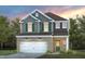 Charming two-story home featuring a brick facade, attached two-car garage, and a well-manicured lawn at 517 Providence Springs Ln, Fuquay Varina, NC 27526