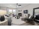 Comfortable living room featuring a fireplace, large windows, and stylish decor for relaxation at 517 Providence Springs Ln, Fuquay Varina, NC 27526