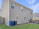 Back of a two story house with a wooden deck, outdoor seating, and a well-maintained lawn at 5321 Carnelian Dr, Raleigh, NC 27610