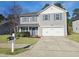 Charming two-story home with a well-maintained lawn and a two car attached garage at 5321 Carnelian Dr, Raleigh, NC 27610