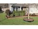 Landscaped front yard featuring lush bushes, grass, mulch beds, and a charming home exterior at 5321 Carnelian Dr, Raleigh, NC 27610