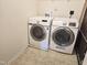 Bright laundry room featuring Samsung washer and dryer and neutral tile flooring at 5321 Carnelian Dr, Raleigh, NC 27610