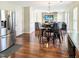 Open-concept living room with hardwood floors, stone fireplace, and stainless steel refrigerator at 5321 Carnelian Dr, Raleigh, NC 27610