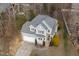Aerial view of charming two-story home with a well-manicured lawn and mature trees at 5806 Whispering Meadow Ln, Durham, NC 27712