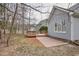 Exterior of a lovely home featuring a spacious wooden deck and brick patio overlooking the backyard at 5806 Whispering Meadow Ln, Durham, NC 27712