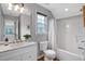 Bathroom features a shower/tub, toilet, sink, and a window that provides natural light at 5806 Whispering Meadow Ln, Durham, NC 27712