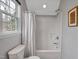 Bright bathroom with a window overlooking a backyard view includes a shower and tub at 5806 Whispering Meadow Ln, Durham, NC 27712