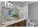 Bathroom featuring a double sink vanity with marble countertop and modern lighting at 5806 Whispering Meadow Ln, Durham, NC 27712