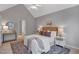 Cozy bedroom with a queen-sized bed, a ceiling fan, and neutral decor at 5806 Whispering Meadow Ln, Durham, NC 27712