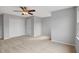 This bedroom includes carpeted floors, a ceiling fan, and a double-door closet for storage at 5806 Whispering Meadow Ln, Durham, NC 27712