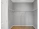 An empty walk-in closet with white shelving at 5806 Whispering Meadow Ln, Durham, NC 27712