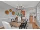 Dining room features hardwood floors, chandelier, and arched doorway leading to the kitchen and living room at 5806 Whispering Meadow Ln, Durham, NC 27712