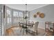 Elegant dining room filled with natural light, featuring hardwood floors and stylish decor at 5806 Whispering Meadow Ln, Durham, NC 27712