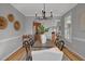 Dining room features hardwood floors, chandelier, and arched doorway leading to the kitchen and living room at 5806 Whispering Meadow Ln, Durham, NC 27712