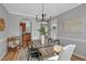 Stylish dining room with hardwood floors and a modern chandelier, perfect for entertaining guests at 5806 Whispering Meadow Ln, Durham, NC 27712