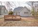 Exterior of a lovely home featuring a spacious wooden deck with a picnic table and sliding glass doors at 5806 Whispering Meadow Ln, Durham, NC 27712