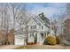 Beautiful two-story home with a manicured lawn, neutral siding and roof, and mature trees on a partially cloudy day at 5806 Whispering Meadow Ln, Durham, NC 27712