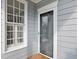 Close-up of front door and window, highlighting the architectural details and natural light at 5806 Whispering Meadow Ln, Durham, NC 27712