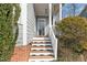 Inviting front porch with wood steps and white railings, leading to a charming home entrance at 5806 Whispering Meadow Ln, Durham, NC 27712