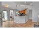 Eat-in kitchen and breakfast bar flow into a dining room with stainless steel appliances and wood cabinets at 5806 Whispering Meadow Ln, Durham, NC 27712
