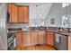 Open-concept kitchen with stainless steel appliances, granite counters, and a view into the inviting living space at 5806 Whispering Meadow Ln, Durham, NC 27712