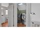Easy access laundry room with washer, dryer, white cabinets and modern lighting at 5806 Whispering Meadow Ln, Durham, NC 27712