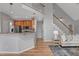 Open concept kitchen and staircase, with view into living room and features an adjacent seating area at 5806 Whispering Meadow Ln, Durham, NC 27712