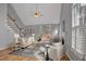 Bright living room features vaulted ceilings, hardwood floors, fireplace, and sliding doors leading to deck at 5806 Whispering Meadow Ln, Durham, NC 27712