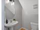 This powder room features a pedestal sink, modern fixtures and a toilet at 5806 Whispering Meadow Ln, Durham, NC 27712