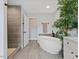 Spa-like bathroom with a free-standing tub, walk-in shower, and modern fixtures at 5945 Four Townes Ln, Raleigh, NC 27616
