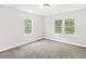Bright bedroom with neutral walls, carpeted floors, and large windows at 5945 Four Townes Ln, Raleigh, NC 27616