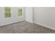 Neutral bedroom with carpeted floors, bright windows, and ample natural light at 5945 Four Townes Ln, Raleigh, NC 27616