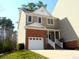 Charming two-story home with brick accents, attached garage, and inviting front porch at 5945 Four Townes Ln, Raleigh, NC 27616