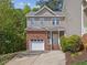 Charming two-story home featuring a brick and vinyl exterior with an attached garage and landscaped front yard at 5945 Four Townes Ln, Raleigh, NC 27616